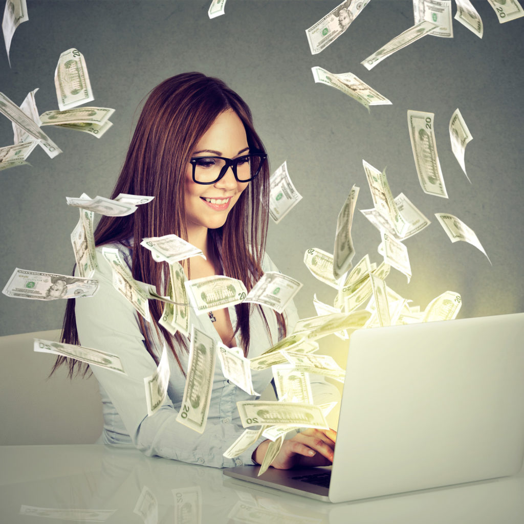 Professional smart young woman using a laptop building online business making money dollar bills cash coming out of computer. Beginner IT entrepreneur success economy concept