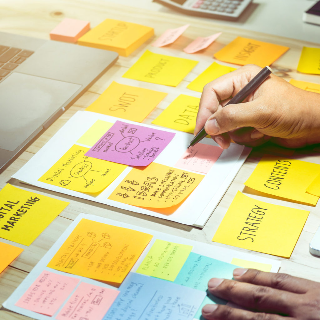 businessman working with notepaper of strategy ideas.Business communication, brainstorming,meeting,plan conceptsNotepaper with male hand.Business brainstorming and communication marketing plan concepts